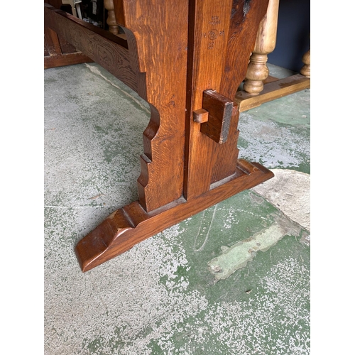 67 - A large oak three plank refectory table on carved legs with pegged cross stretcher by Batesy Lamborn... 