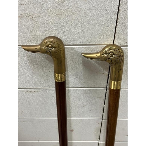 173 - A pair of walking sticks with ducks head handles both unscrewed into four parts