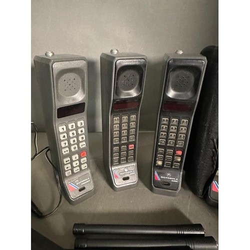 175 - Four vintage Motorola “brick” mobile telephones with two chargers and bag