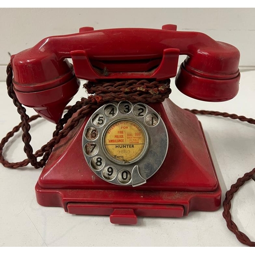 200 - A 1950's red Bakelite telephone with twist cord 1/232 CBS38/1