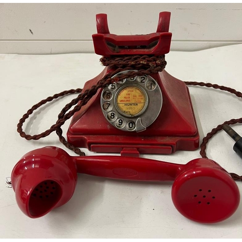 200 - A 1950's red Bakelite telephone with twist cord 1/232 CBS38/1