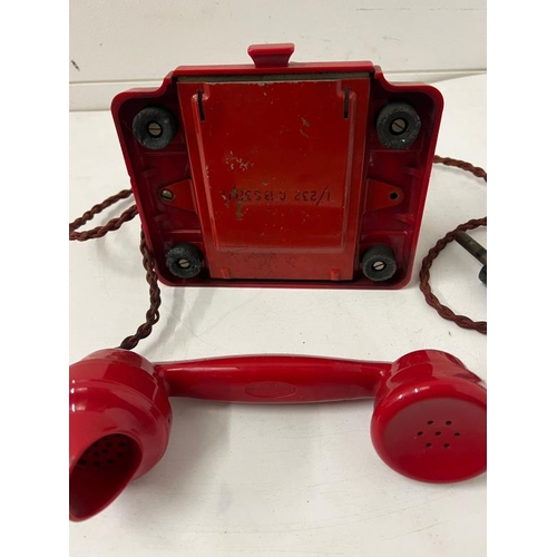 200 - A 1950's red Bakelite telephone with twist cord 1/232 CBS38/1