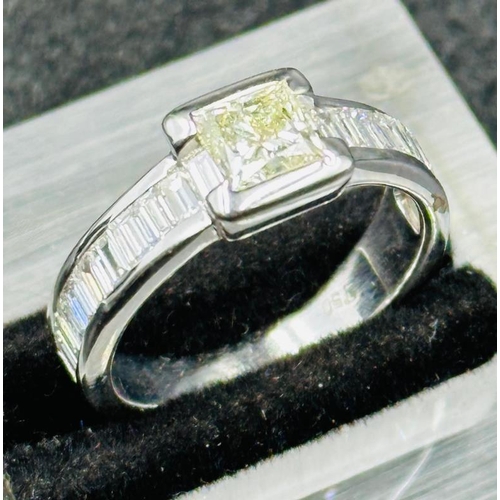 47 - A hallmarked 18ct white gold princess and baguette cut diamond ring, consisting of a central 5.50mm ... 