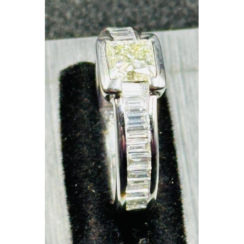 47 - A hallmarked 18ct white gold princess and baguette cut diamond ring, consisting of a central 5.50mm ... 