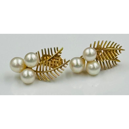 54 - A pair of gold and pearl earrings, marked 14K, with an approximate weight of 6g.