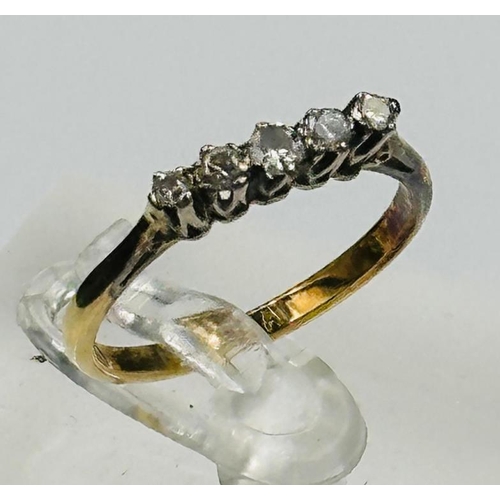 74 - An 18ct gold and platinum set five stone diamond ring,approximate size O and weight 2.1g