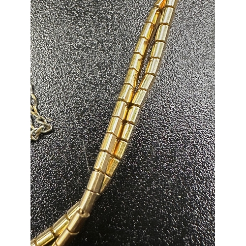 68A - An 18ct yellow gold two strand bracelet with an approximate weight of 13.8g, marked 750