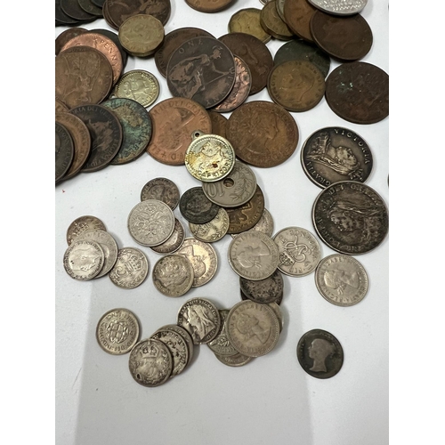 132B - A selection of Uk coinage, some silver content, six pence and three pennies along with Victorian and... 