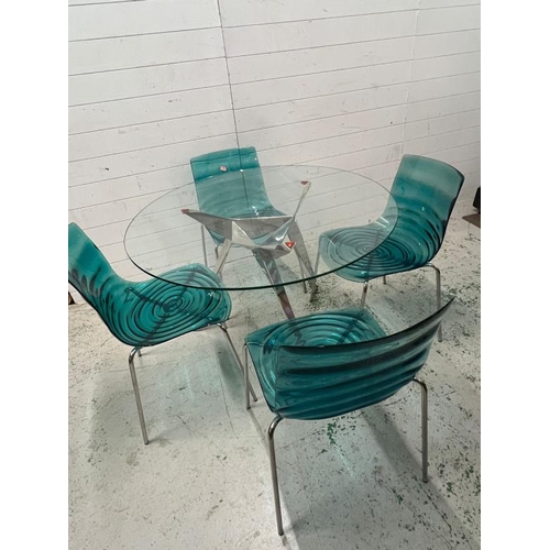 100 - L'eau chairs, metal frame and transparent wave technopoymer shell seat with a glass dining table on ... 