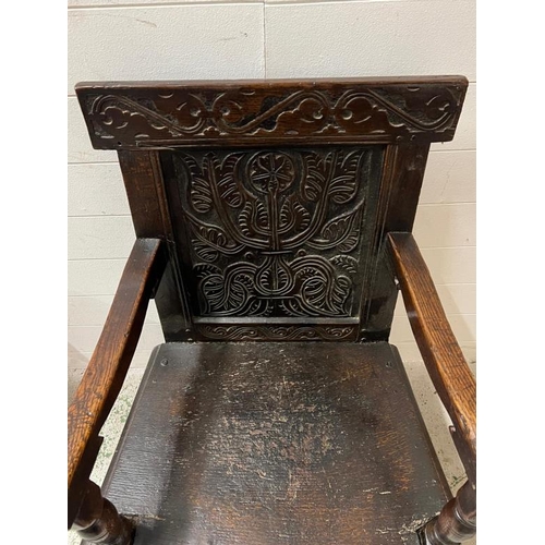 127 - An oak Wainscot hall chair with carved back