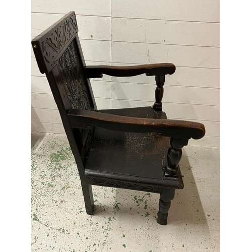 127 - An oak Wainscot hall chair with carved back