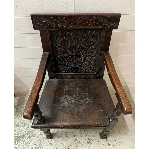 127 - An oak Wainscot hall chair with carved back