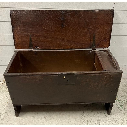 129 - An oak coffer, single plank top opening to reveal interior with a candle box and raised feet (H57cm ... 