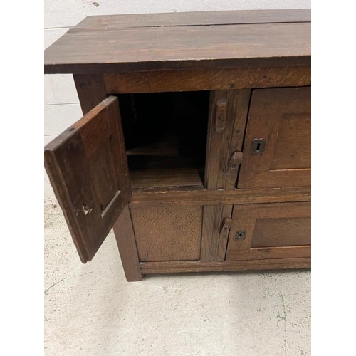 130 - An oak two plank side cupboard (H77cm W105cm D46cm)