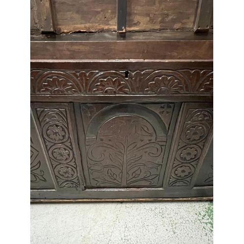 132 - An English oak coffer with decorative carved panels (H67cm W150cm D54cm)