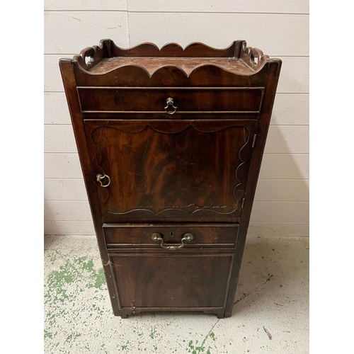 147 - A mahogany bedside cabinet, gallery top with hand cut outs opening to slide pull out stand and cupbo... 