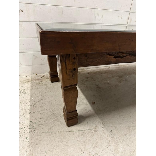 150 - A mahogany glass topped coffee table, the wooden top upcycled from a cupboard door (H48cm W133cm D69... 