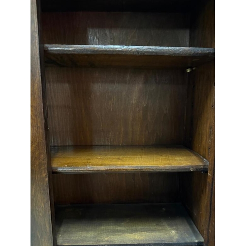 155 - An Arts and Crafts style bookcase bureau comprising of a two door stained glass cupboard over a bure... 