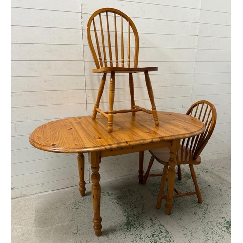 161 - A pine extendable kitchen table and two stick back chairs (H76cm W138cm D78cm)