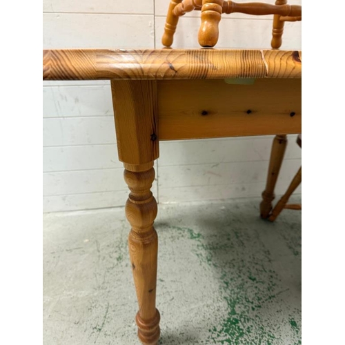 161 - A pine extendable kitchen table and two stick back chairs (H76cm W138cm D78cm)