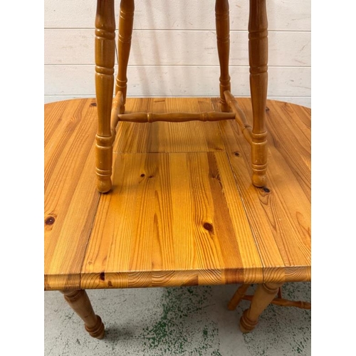 161 - A pine extendable kitchen table and two stick back chairs (H76cm W138cm D78cm)