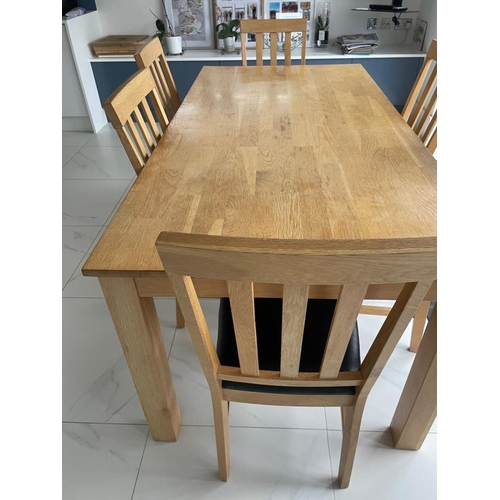 162 - A contemporary pine kitchen table and six faux black leather dining chairs (H76cm W1841cm D89cm)