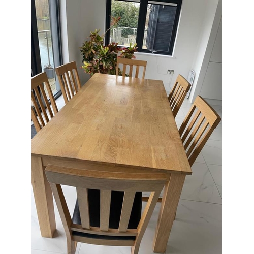 162 - A contemporary pine kitchen table and six faux black leather dining chairs (H76cm W1841cm D89cm)