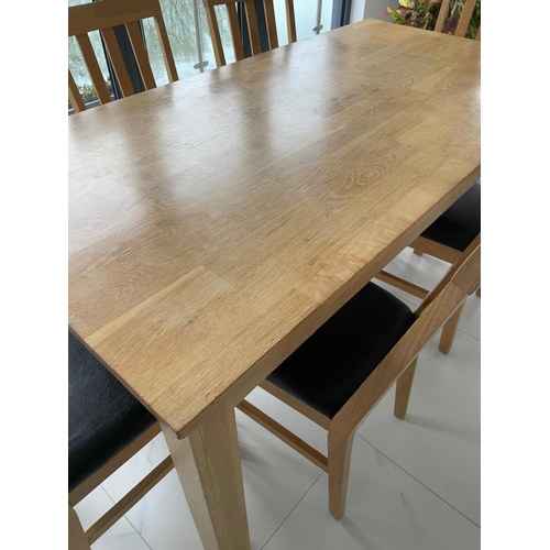 162 - A contemporary pine kitchen table and six faux black leather dining chairs (H76cm W1841cm D89cm)