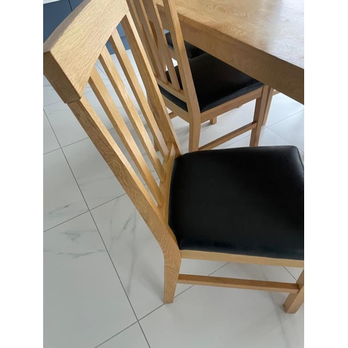 162 - A contemporary pine kitchen table and six faux black leather dining chairs (H76cm W1841cm D89cm)