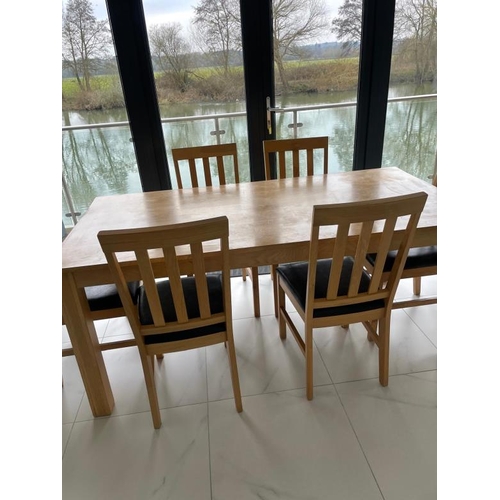 162 - A contemporary pine kitchen table and six faux black leather dining chairs (H76cm W1841cm D89cm)