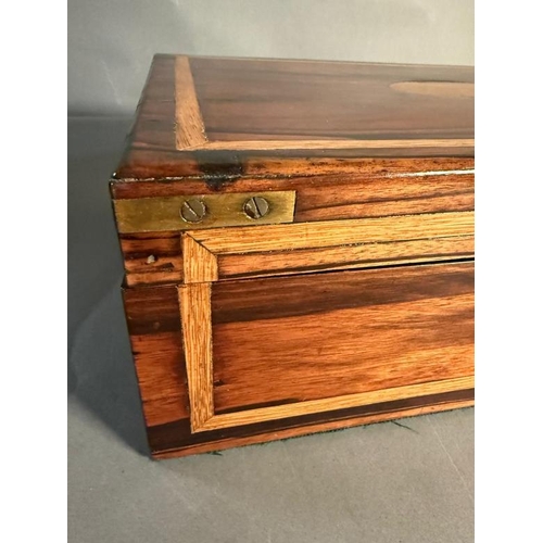 167 - A coromandel wood campaign style box with brass handles and black central escutcheon