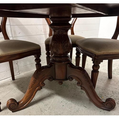 178 - A mahogany circular dining table on a heavily carved pedestal base and splayed scrolling legs with s... 