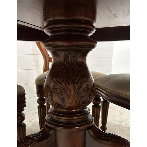 178 - A mahogany circular dining table on a heavily carved pedestal base and splayed scrolling legs with s... 