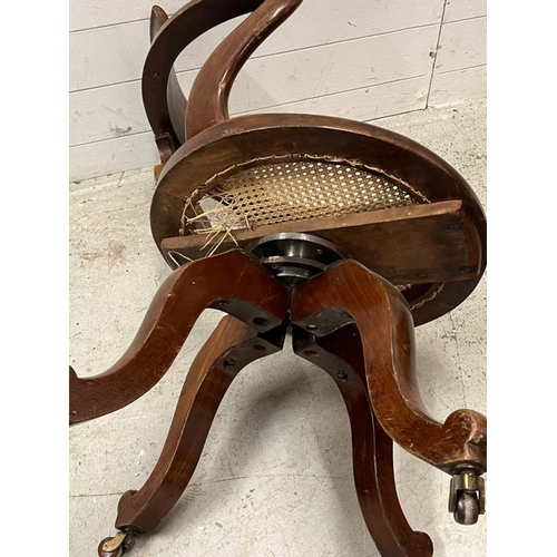 189 - A Victorian revolving chair with cane seat AF