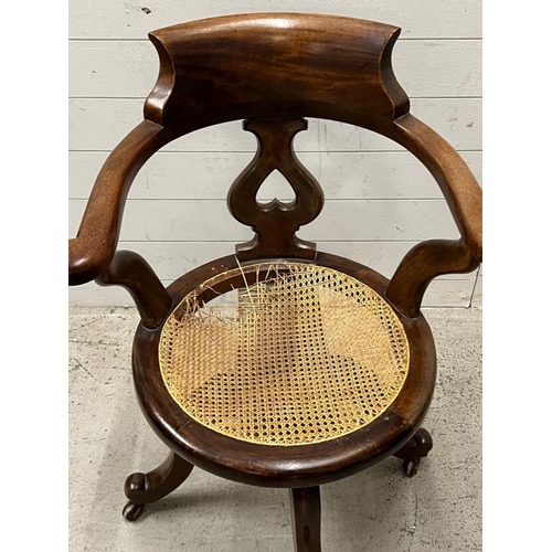 189 - A Victorian revolving chair with cane seat AF