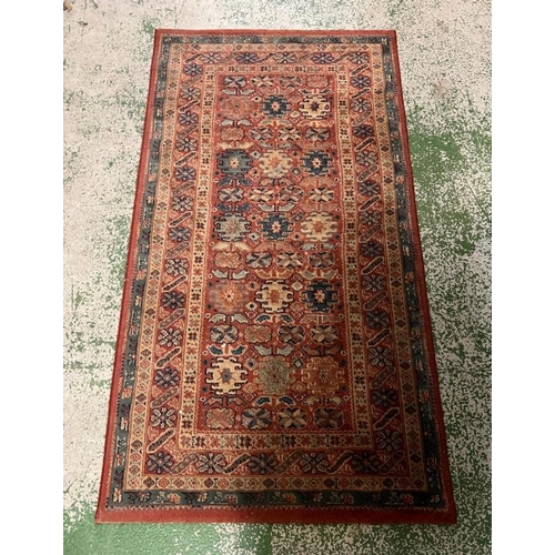 205 - A red ground rug with blue boarder 153cm x 80cm