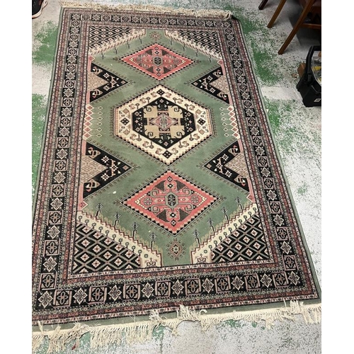 206 - A green ground rug with diamond design to centre 250cm x 160cm