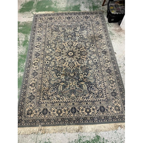 207 - A green and blue rug with a central medallion 250cm x 160cm