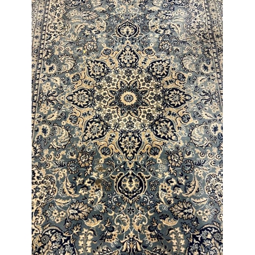 207 - A green and blue rug with a central medallion 250cm x 160cm