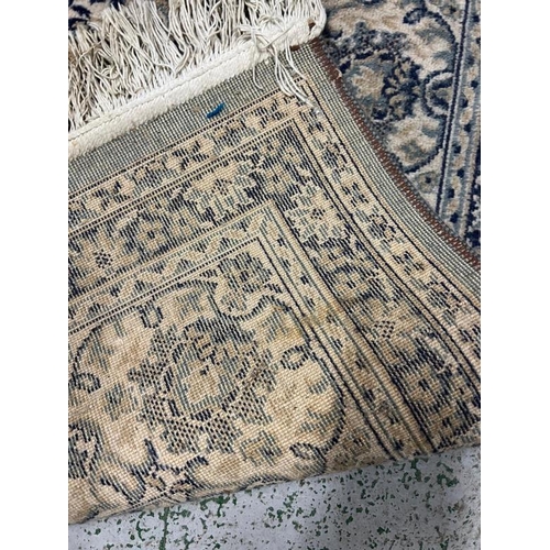 207 - A green and blue rug with a central medallion 250cm x 160cm