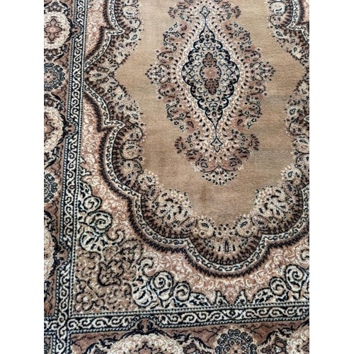 210 - A wool rug, brown grounds with central medallion and geometric boarder 200cm x 140cm