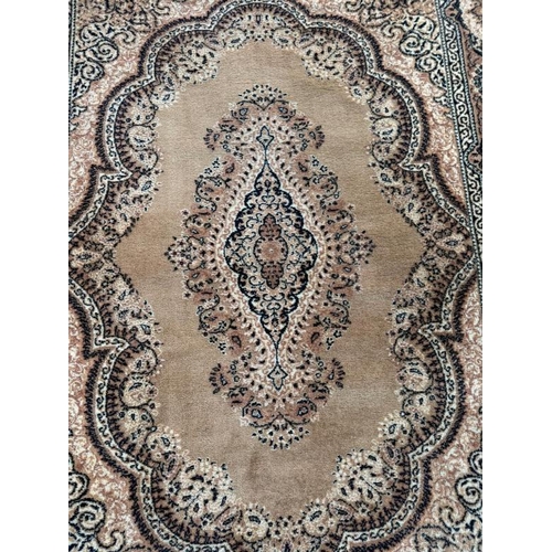 210 - A wool rug, brown grounds with central medallion and geometric boarder 200cm x 140cm