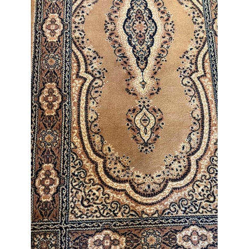 211 - A wool runner, brown grounds with central medallion and geometric boarder 180cm x 90cm