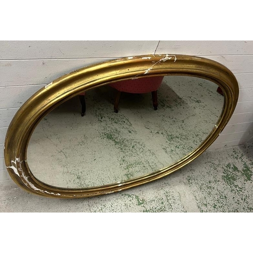 214 - A substantial oval gilt wall mirror, plaster frame AF (Frame 102cm x 128cm)