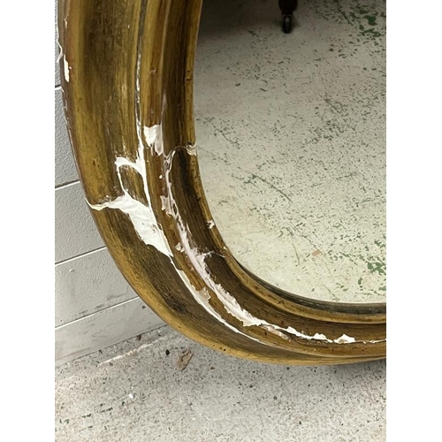 214 - A substantial oval gilt wall mirror, plaster frame AF (Frame 102cm x 128cm)