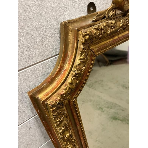 218 - A French giltwood mirror with scrolling crest, floral swags shaped mirror plate (150cm x 96cm)