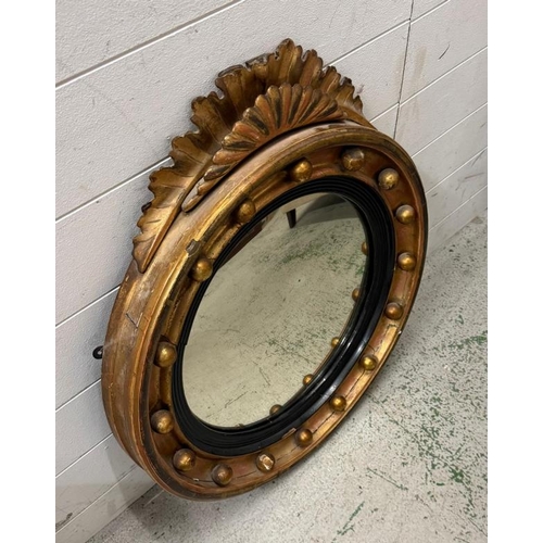 219 - An 19th Century giltwood and Gesso convex wall mirror with a fan pendant (H68cm Dia58cm)