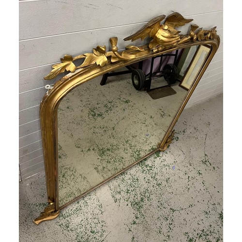 223 - A gilt frame large mantel or hall mirror, carved eagle with oak leaves sits upon an arch top and oak... 