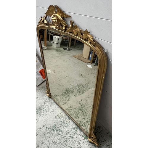 223 - A gilt frame large mantel or hall mirror, carved eagle with oak leaves sits upon an arch top and oak... 