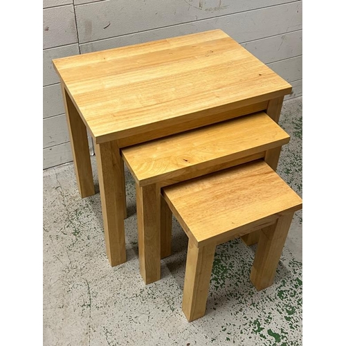 24 - A light oak nest of tables (H53cm W55cm D40cm)